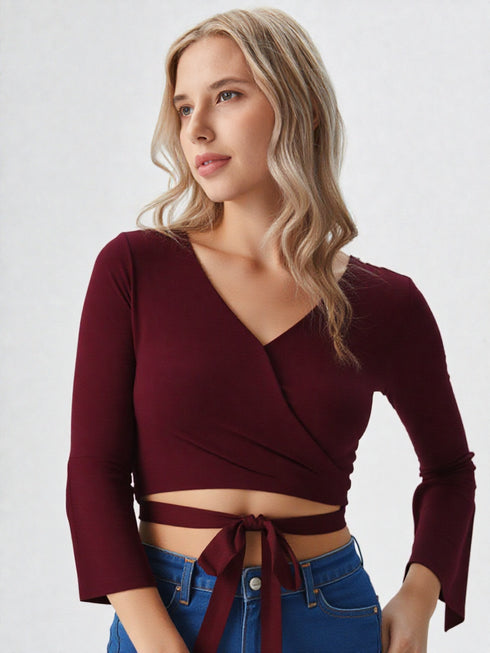 Maroon wrap crop top with flared long sleeves and tie waist in polyester fabric, stylish women’s evening wear