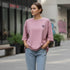 Mauve cotton oversized t-shirt with a small minimal chest logo worn by a woman