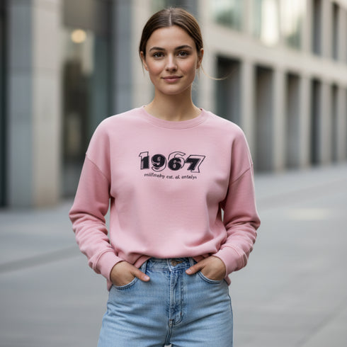 Pink cotton sweatshirt with a bold 1967 front graphic worn by a woman