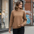 Brown minimal crewneck sweatshirt worn by a woman in a street setting
