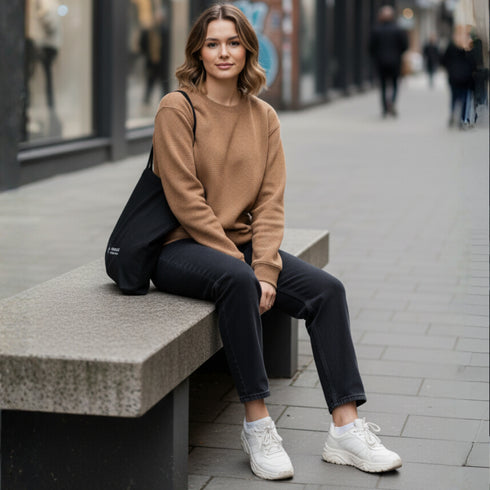 Brown minimal crewneck sweatshirt worn by a woman in a street setting
