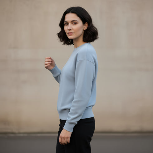Light blue minimal crewneck sweatshirt worn by a woman