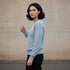 Light blue minimal crewneck sweatshirt worn by a woman