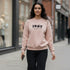 Beige crewneck sweatshirt with a 1967 front graphic worn by a woman
