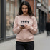 Beige crewneck sweatshirt with a 1967 front graphic worn by a woman