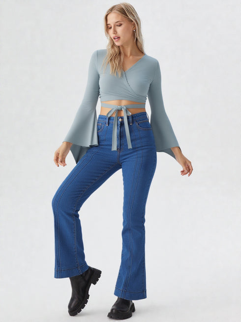 Light blue wrap tie long sleeve crop top on model, chic polyester blouse