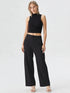 Black ribbed sleeveless crop top with mock neck and front twist design