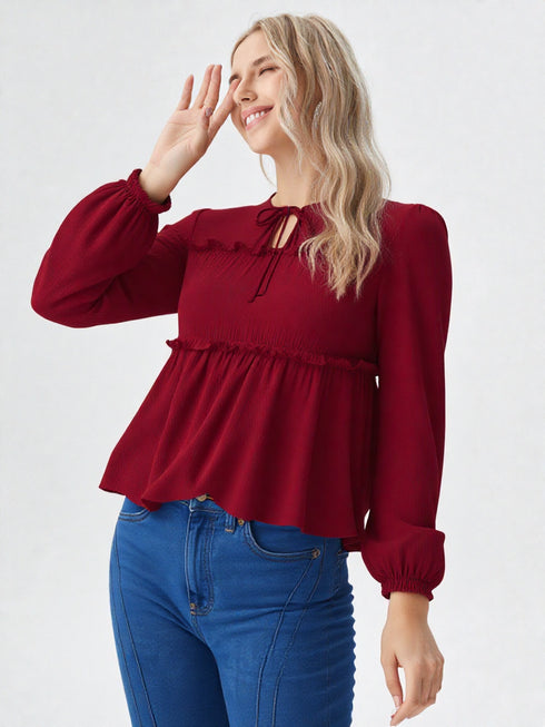 Maroon long sleeve smocked peplum top with tie-up neckline and flowy hem, women’s elegant casual wear
