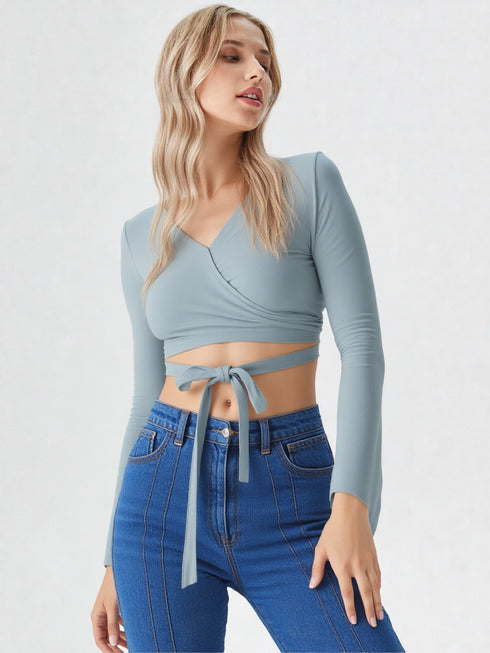 Light blue wrap tie long sleeve crop top on model, chic polyester blouse