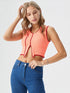 Peach sleeveless crop top with red contrast piping and asymmetrical hem, women’s trendy streetwear