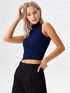 Close-up of woman wearing navy blue mock neck sleeveless ribbed top with crossover waist design