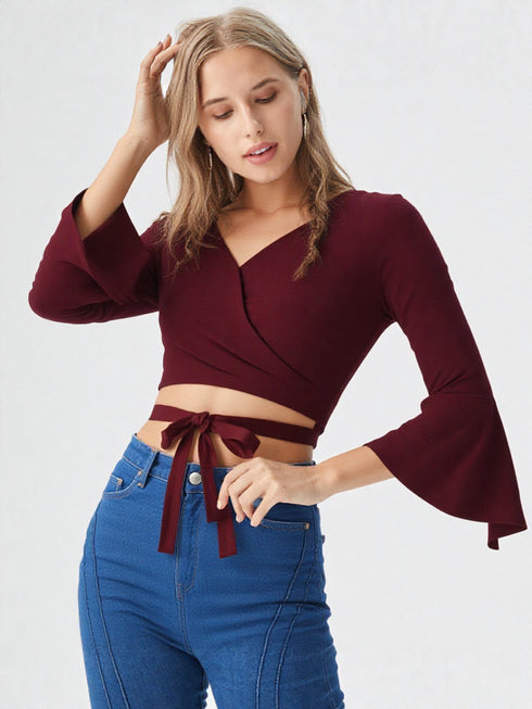 Maroon wrap crop top with flared long sleeves and tie waist in polyester fabric, stylish women’s evening wear