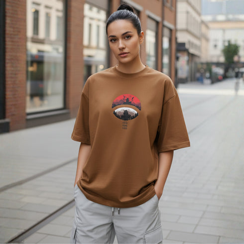 Model wearing brown oversized cotton t-shirt with anime-inspired front graphic print