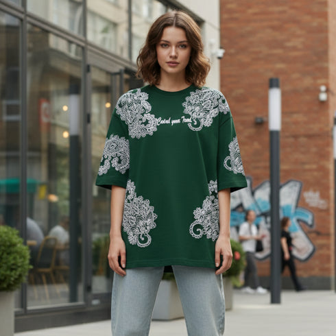 Dark green cotton oversized t-shirt with white ornate all-over pattern worn by a woman