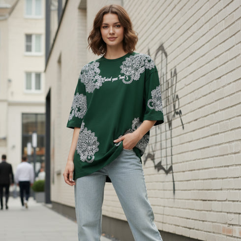 Dark green cotton oversized t-shirt with white ornate all-over pattern worn by a woman