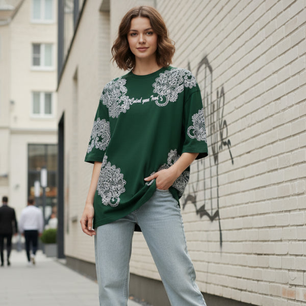 Dark green cotton oversized t-shirt with white ornate all-over pattern worn by a woman