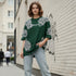Dark green cotton oversized t-shirt with white ornate all-over pattern worn by a woman
