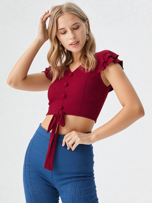 Woman wearing a red ruffle sleeve tie-front crop top with buttons