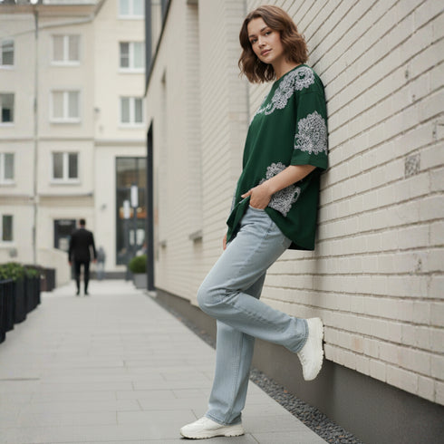 Dark green cotton oversized t-shirt with white ornate all-over pattern worn by a woman
