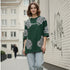 Dark green cotton oversized t-shirt with white ornate all-over pattern worn by a woman