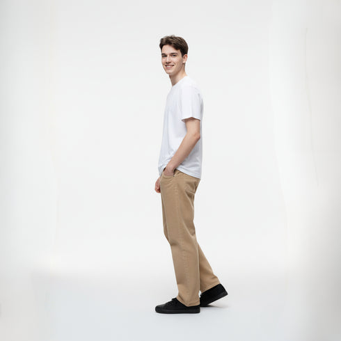 Beige baggy fit denim pants for men styled with white t-shirt and black shoes