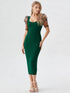 Woman wearing a green bodycon midi dress with embroidered puff mesh sleeves