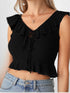 Woman wearing a black ruffle tie-front crop top with peplum hem and blue jeans