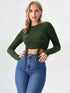 Woman wearing a dark green ruched drawstring long sleeve crop top