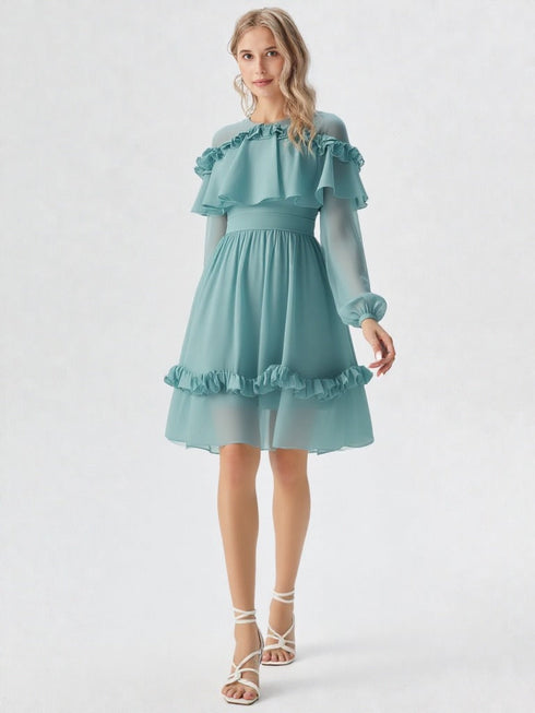 Woman wearing teal ruffle off shoulder long sleeve dress with layered detailing and white heels