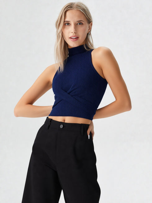 Close-up of woman wearing navy blue mock neck sleeveless ribbed top with crossover waist design