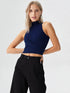 Close-up of woman wearing navy blue mock neck sleeveless ribbed top with crossover waist design