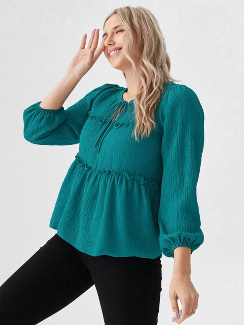 Teal peplum long sleeve top with tie-neck and puff sleeves