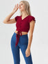 Woman wearing a red ruffle sleeve tie-front crop top with buttons