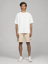 White Oversized Basic T-Shirt for men styled with beige shorts