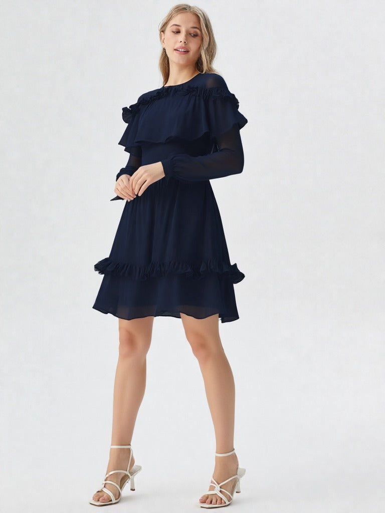 Woman wearing navy blue ruffle layer long sleeve dress with flowy hem  