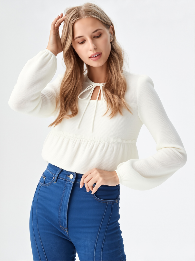 Close-up of woman wearing white ruffle detail tie neck blouse with long sleeves  